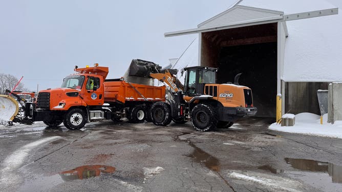 The Department of Public Works Division of Streets and Road Operations trucks get ready to treat roads during a powerful winter storm making its way through the area Sunday.