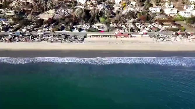 Destroyed homes and business line the beach in Malibu.