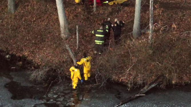 The man is helped by firefighters and paramedics after being rescued.