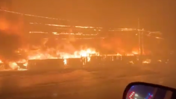 One of the burning structures Komarovsk sees during her evacuation.