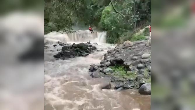 Firefighter airlifted in to save girl from rushing stream.