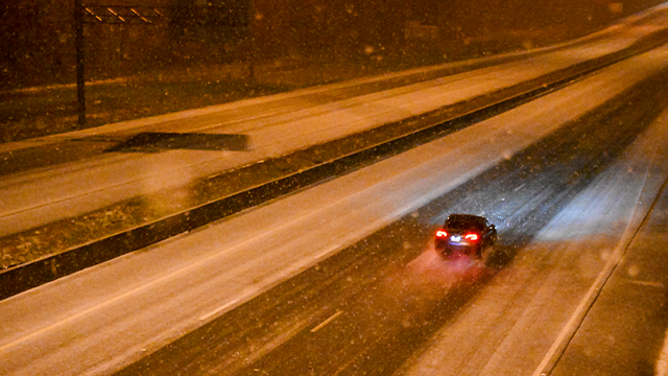 TALLAHASSEE, FLORIDA - JANUARY 21: A car drives along a road during a winter storm on January 21, 2025 in Tallahassee, Florida. The National Weather Service has placed North Florida under a winter storm warning with some predicting the Gulf's biggest snow and ice storm in more than 100 years. (Photo by Miguel J. Rodriguez Carrillo/Getty Images)