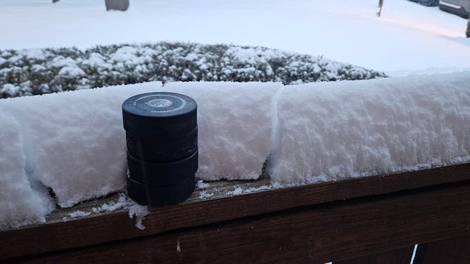 Snow in Tysons Corner, Virginia measured with hockey pucks on Monday, Jan. 6, 2024. 