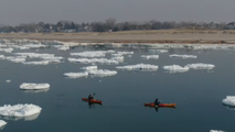 Drone video shows kayakers navigating giant 'ice pancakes' on Lake Michigan