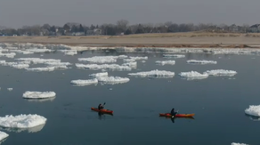 Drone video shows kayakers navigating giant 'ice pancakes' on Lake Michigan