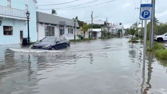 A car navigates a flooded road in Key West, Florida, on Feb. 24, 2025.