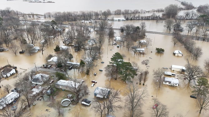 Aerial photos show homes and buildings flooded after a levee failed in Rives, Tennessee.