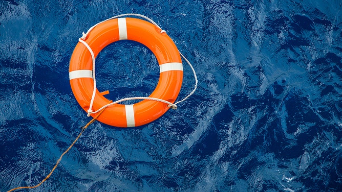 Safety equipment, Life buoy or rescue buoy floating on sea to rescue people from drowning man.
