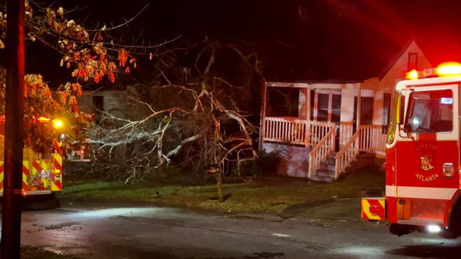 Atlanta First responders at home where man died after tree collapsed.