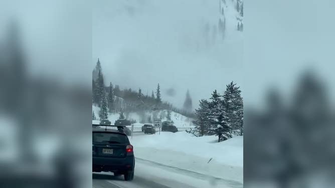 Drivers on I-70 pass an avalanche Monday morning on a mountain next to the highway.