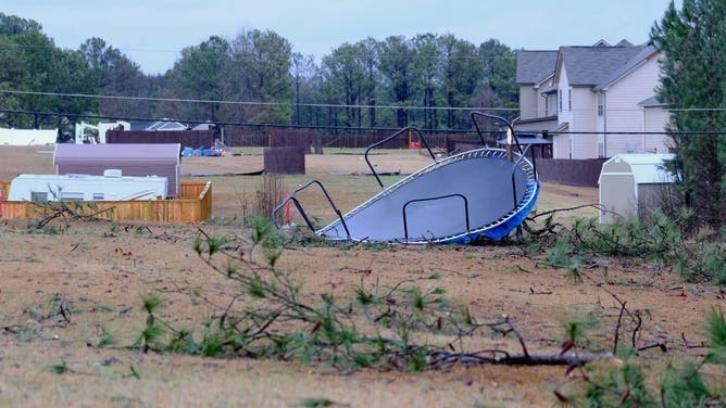 A trampoline is flipped over after severe weather hit Rex, Georgia.