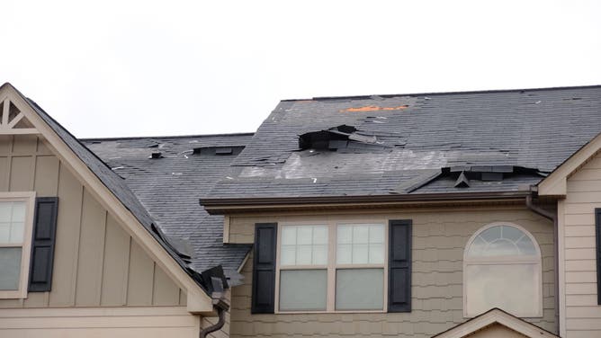 The roof of a home is damaged after storms hit Clayton County, Georgia. 
