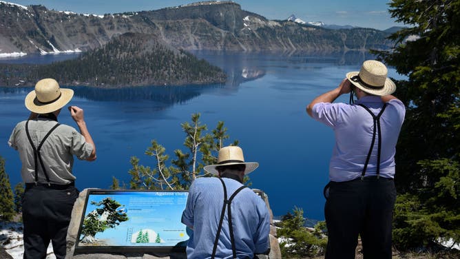 Men visit Crater Lake National Park in Oregon, USA