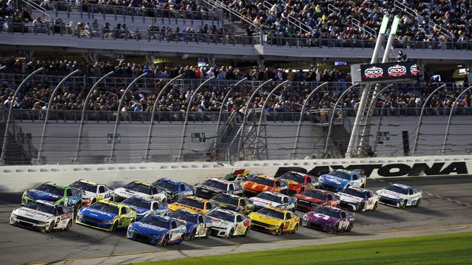 DAYTONA BEACH, FLORIDA - FEBRUARY 19: Austin Cindric, driver of the #2 Discount Tire Ford, Kyle Busch, driver of the #8 Zone Chevrolet, Ryan Blaney, driver of the #12 Menards/PEAK Ford, and Kyle Larson, driver of the #5 HendrickCars.com Chevrolet, race during the NASCAR Cup Series Daytona 500 at Daytona International Speedway on February 19, 2024 in Daytona Beach, Florida.