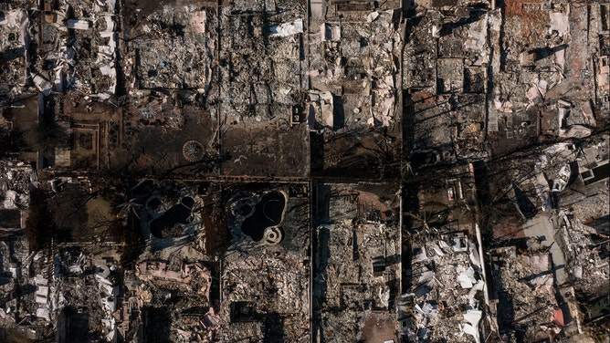 An aerial image shows homes damaged and destroyed by the Palisades Fire in the Pacific Palisades neighborhood of Los Angeles, California, on January 29, 2025.