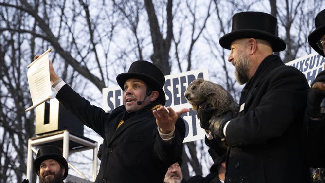 PENNSYLVANIA, UNITED STATES - FEBRUARY 02: Groundhog Club handler A.J. Dereume holds Punxsutawney Phil, the weather prognosticating groundhog, during the 139th celebration of Groundhog Day on Gobbler's Knob in Punxsutawney, Pennsylvania on February 2, 2025. Phil's handlers said that the groundhog has forecast six more weeks of winter. (Photo by Mostafa Bassim/Anadolu via Getty Images)