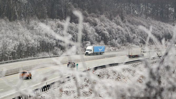 OMERSET, PENNSYLVANIA - FEBRUARY 6: Traffic moves through the mountains surrounded by iced trees Thursday morning after freezing rain fell on the area Wednesday night before heading east on February 6, 2025 in Somerset County, Pennsylvania. Millions of people have been put on alert as the storm moves into New England.