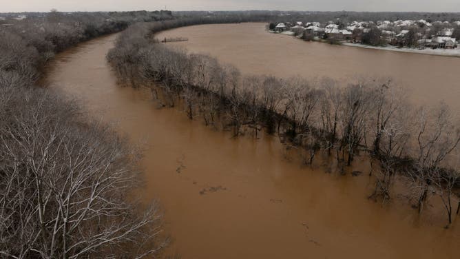In this aerial view, the Barren River floods after a rain storm on February 16, 2025 in Bowling Green, Kentucky. Severe winter storms brought torrential rains causing intense flooding in Kentucky and parts of Florida and Georgia.