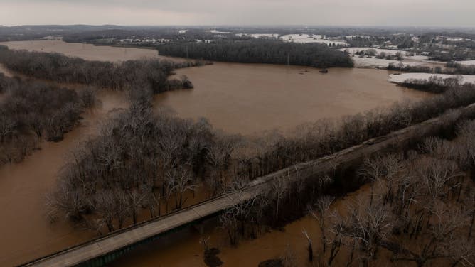 In this aerial view, the Barren River floods around Kentucky Route 185 on February 16, 2025 in Bowling Green, Kentucky. Severe winter storms brought torrential rains causing intense flooding in Kentucky and parts of Florida and Georgia.