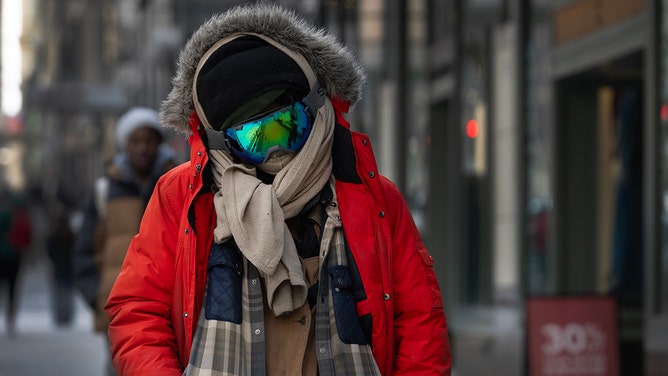 People walk along Michigan Avenue as temperatures hovered in the single-digits on February 17, 2025 in Chicago, Illinois.