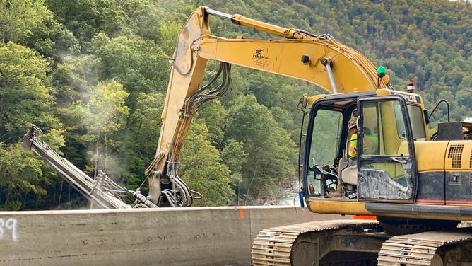 Crews work to clear I-40 after Hurricane Helene destroyed parts of the road. 