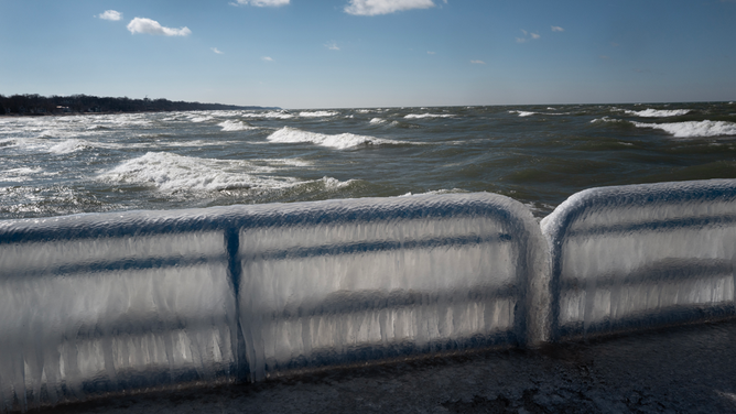 ST. JOSEPH, MICHIGAN - FEBRUARY 18: Ice builds up along a pier on Lake Michigan on February 18, 2024 in St. Joseph, Michigan. The Great Lakes shorelines have historically been ice-covered this time of year, but this winter's warm weather has led to the lowest ice cover over the lakes system since record keeping began in 1973. The loss of ice on the lakes is part of a decades-long trend which has seen the coverage drop by about 5% a year since the 1970s.