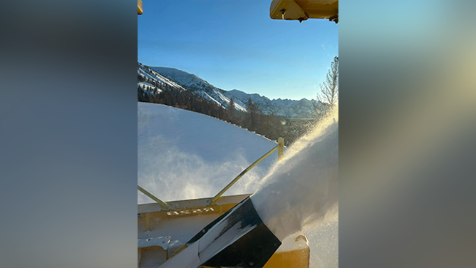 This image shows crews working to remove snow from State Highway 21 in Idaho after an avalanche.