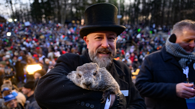 PUNXSUTAWNEY, PENNSYLVANIA - FEBRUARY 2: Groundhog handler AJ Dereume holds Punxsutawney Phil after he saw his shadow predicting 6 more weeks of winter during the 139th annual Groundhog Day festivities on February 2, 2025 in Punxsutawney, Pennsylvania. Groundhog Day is a popular tradition in the United States and Canada. If Punxsutawney Phil sees his shadow he regards it as an omen of six more weeks of bad weather and returns to his den. Early spring arrives if he does not see his shadow, causing Phil to remain above ground. (Photo by Jeff Swensen/Getty Images)