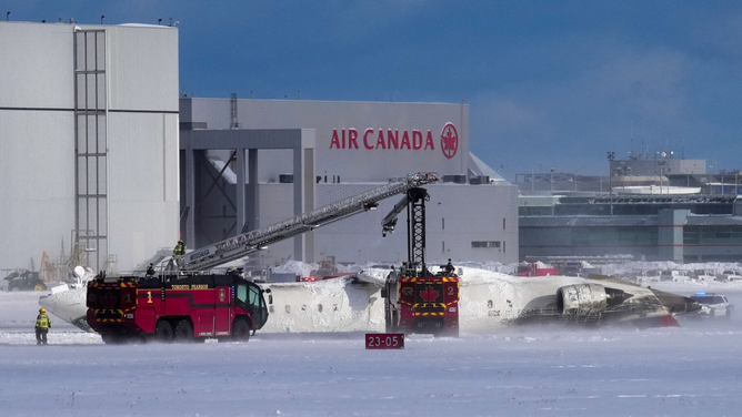 First responders work at the Delta Air Lines plane crash site at Toronto Pearson International Airport in Mississauga, Ontario, Canada February 17, 2025.