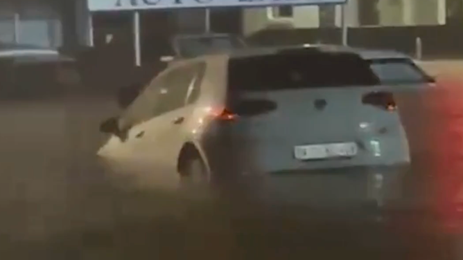 Car floating in floodwater.