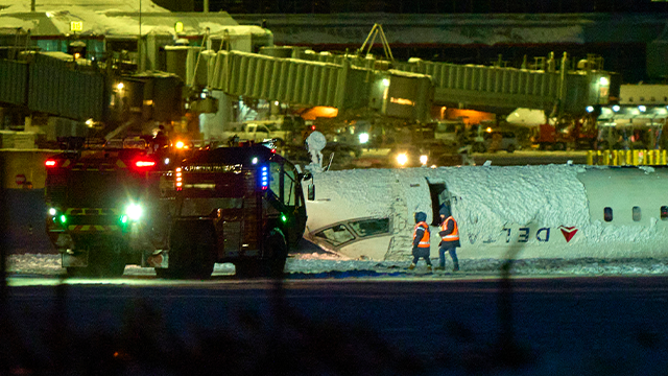 A Delta airlines plane sits on its roof after crashing upon landing at Toronto Pearson Airport in Toronto, Ontario, on February 17, 2025. A Delta Air Lines jet with 80 people onboard crash landed Monday at the Toronto airport, officials said, flipping upside down and leaving at least 15 people injured but causing no fatalities. The Endeavor Air flight 4819 with 76 passengers and four crew was landing at around 3:30 pm in Canada's biggest metropolis, having flown from Minneapolis in the US state of Minnesota, the airline said. (Photo by Geoff Robins / AFP) (Photo by GEOFF ROBINS/AFP via Getty Images)