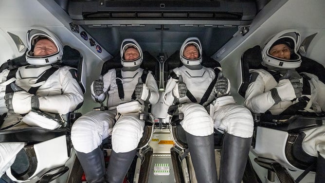 NASA astronaut Butch Wilmore, left, Roscosmos cosmonaut Aleksandr Gorbunov, second from left, and NASA astronauts Nick Hague, second from right, and Suni Williams, right are seen inside a SpaceX Dragon spacecraft onboard the SpaceX recovery ship MEGAN shortly after having landed in the water off the coast of Tallahassee, Florida, Tuesday, March 18, 2025. Hague, Gorbunov, Williams, and Wilmore are returning from a long-duration science expedition aboard the International Space Station.
