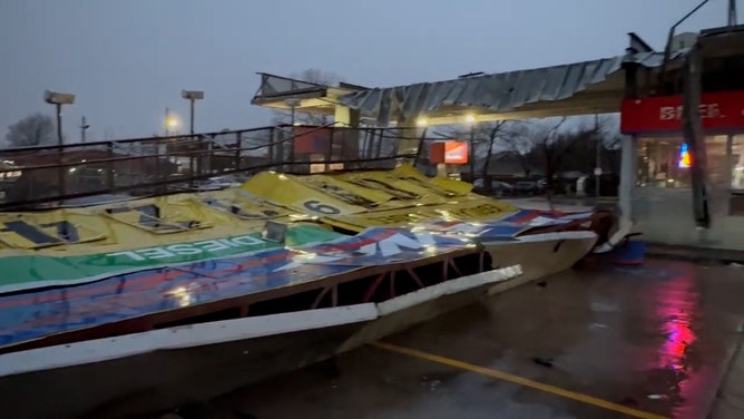 A large gas station sign was toppled in Irving, Texas, in the early hours of Tuesday morning, March 4, as a line of storms brought winds of up to 70 mph to the Dallas-Fort Worth metroplex.