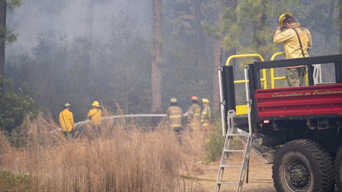 MYRTLE BEACH, SOUTH CAROLINA - MARCH 2: Firefighters battle a blaze in the Carolina Forest neighborhood on March 2, 2025 in Myrtle Beach, South Carolina. Multiple forest fires in the area have caused evacuations along the South Carolina coast.