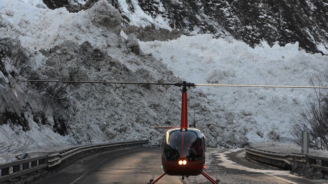 The Richardson Highway, in Alaska, near Mile 16 is still buried under debris from a massive avalanche in Snowslide Gulch near Keystone Canyon and the Lowe River as road crews wait for the flooding to recede on Wednesday, Jan. 29, 2014.