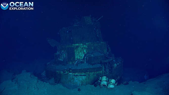 Another possible gun tub found among other debris, such as large cans.