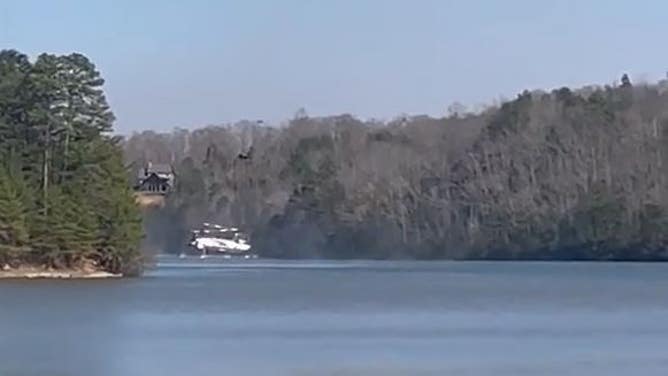 A chinook helicopter scoops up water to drop on the Fish Hook fire in Polk County, NC. 