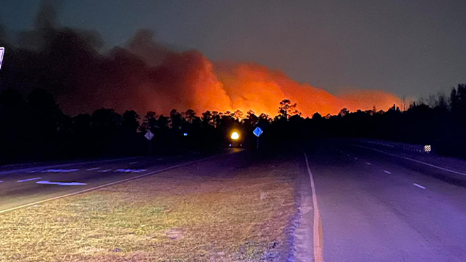 This photo shows flames illuminating the night sky as a wildfire rages in Horry County, South Carolina.