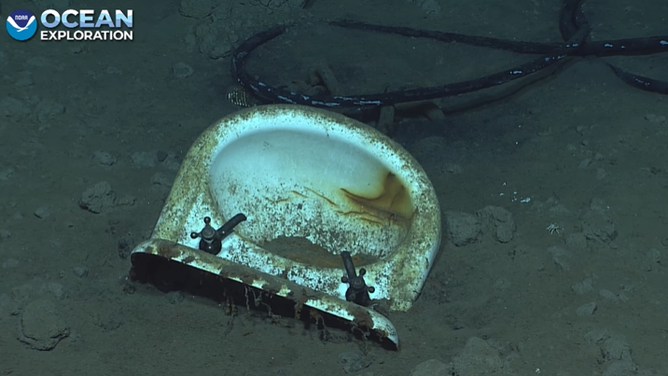 A sink left partially in tact amid other daily items found on the ocean floor of the wreck.