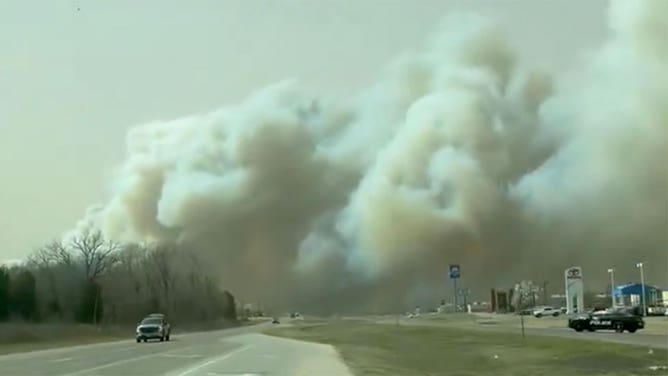 Thick smoke rises from a wildfire burning near Stillwater, Oklahoma, on March 13, 2025.