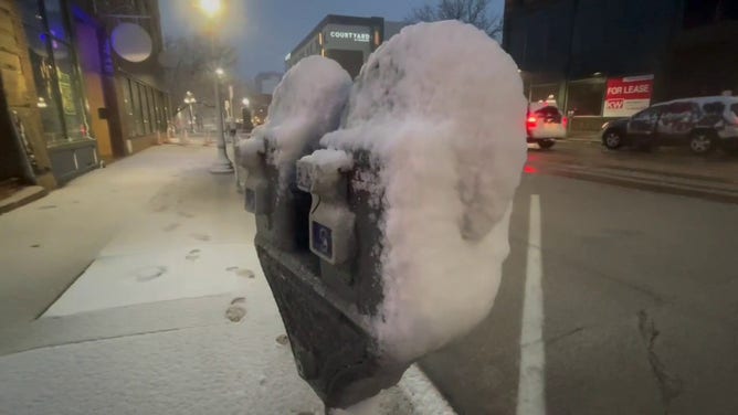 This image shows snow starting to coat roads and sidewalks in Sioux City, Iowa, as a powerful winter storm beginning to impact the region on Wednesday, March 19, 2025.