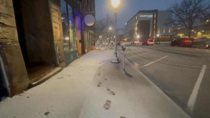 This image shows snow starting to coat roads and sidewalks in Sioux City, Iowa, as a powerful winter storm beginning to impact the region on Wednesday, March 19, 2025.