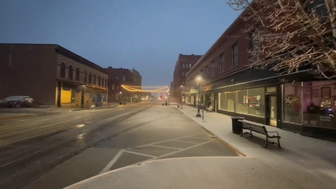 This image shows snow starting to coat roads and sidewalks in Sioux City, Iowa, as a powerful winter storm beginning to impact the region on Wednesday, March 19, 2025.