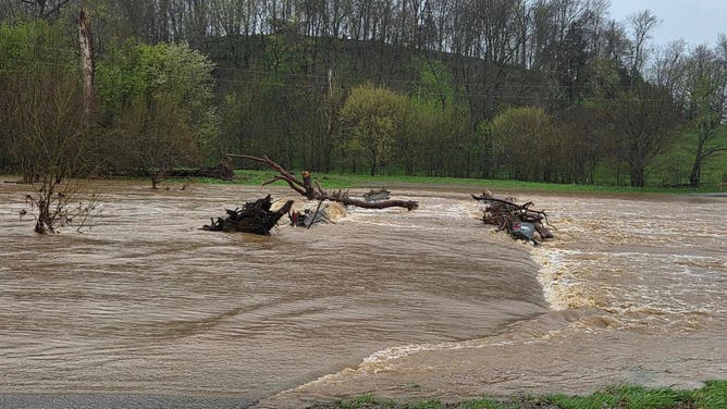 A road disappears under floodwater in Washington County in central Kentucky.