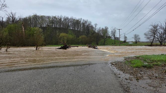 A road disappears under floodwater in Washington County in central Kentucky.