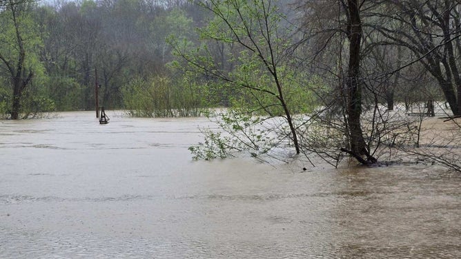 Only a small portion of the cable towers near Houchin Ferry Campground are visible above the flooded Green River on the afternoon of Sunday, April 6, 2025.