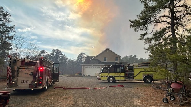 firefighters are on the scene of a fire in a rural area