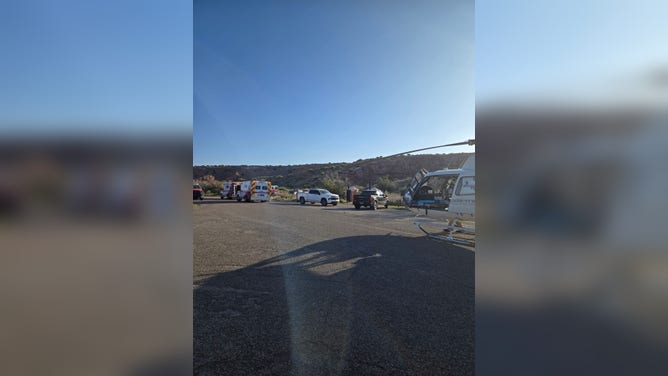 A medical helicopter prepares to extract a female victim.