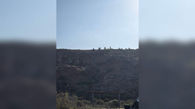 First responders stand at the top of the Bottomless Lakes Area upon arrival.