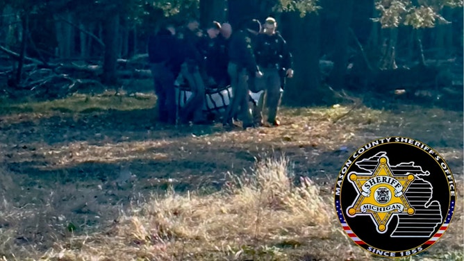 A missing Michigan woman was found alive in a heavily wooded area, enduring harsh weather conditions while sheltering next to a fallen tree, deputies said.